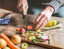 A person slices vegetables.